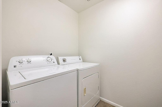 laundry room featuring laundry area, baseboards, and washing machine and dryer