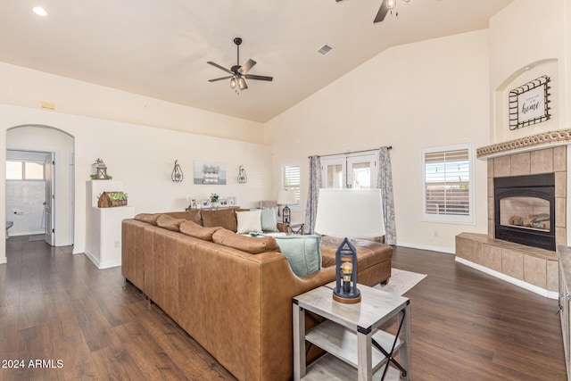 living room featuring a fireplace, dark hardwood / wood-style floors, ceiling fan, and high vaulted ceiling