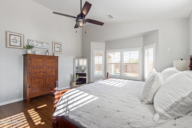 bedroom featuring dark hardwood / wood-style flooring, ceiling fan, and lofted ceiling