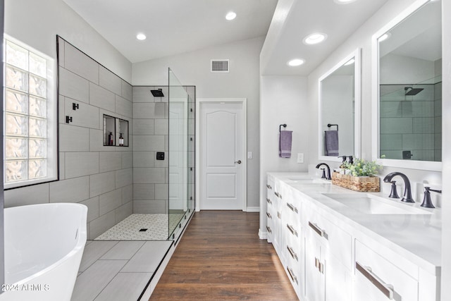 bathroom featuring independent shower and bath, wood-type flooring, vanity, and lofted ceiling