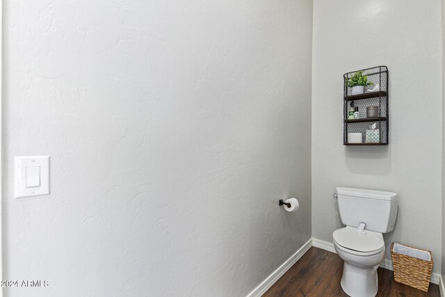 bathroom with toilet and hardwood / wood-style flooring