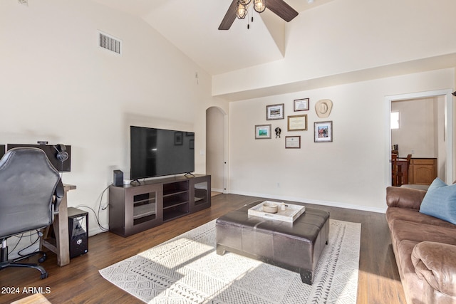 living room featuring ceiling fan, dark hardwood / wood-style floors, and high vaulted ceiling