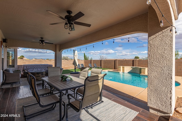 view of patio featuring ceiling fan and a fenced in pool