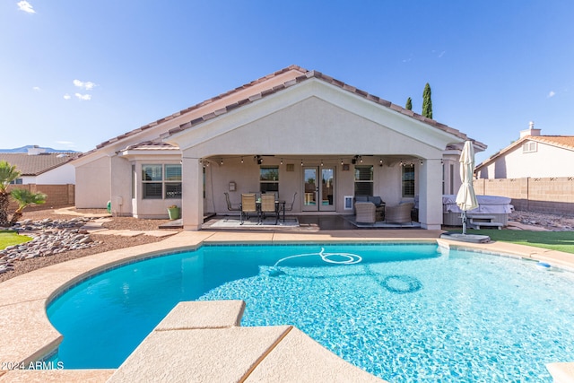 view of swimming pool featuring french doors, ceiling fan, and a patio area