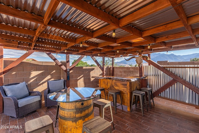 view of patio / terrace with an outdoor bar and a deck with mountain view