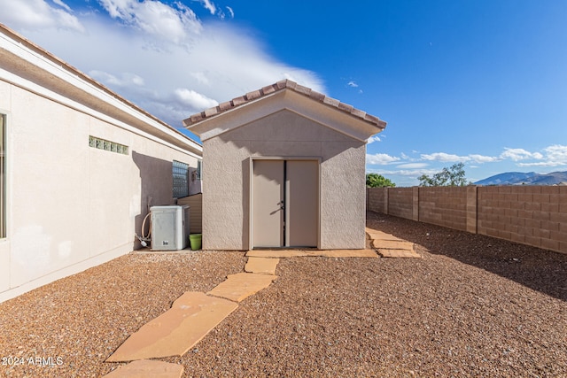 view of outbuilding with a mountain view and ac unit