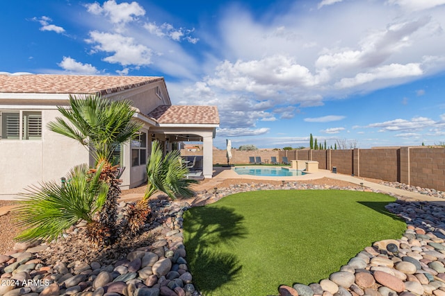 view of yard with a fenced in pool and a patio area