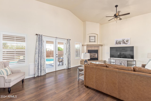 living room featuring ceiling fan, vaulted ceiling, dark hardwood / wood-style floors, and a fireplace