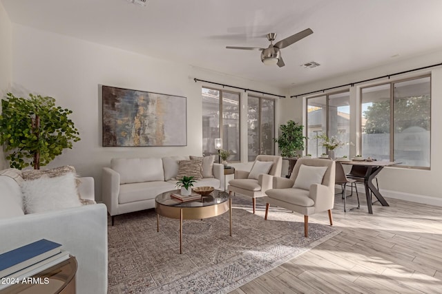 living room with hardwood / wood-style flooring and ceiling fan