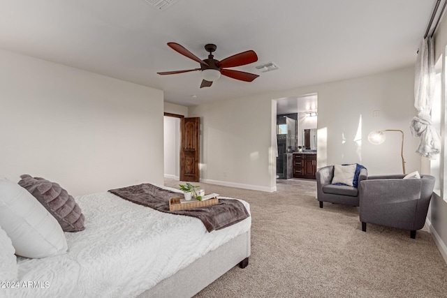 carpeted bedroom featuring ensuite bath and ceiling fan