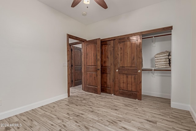 unfurnished bedroom with a closet, light hardwood / wood-style flooring, and ceiling fan