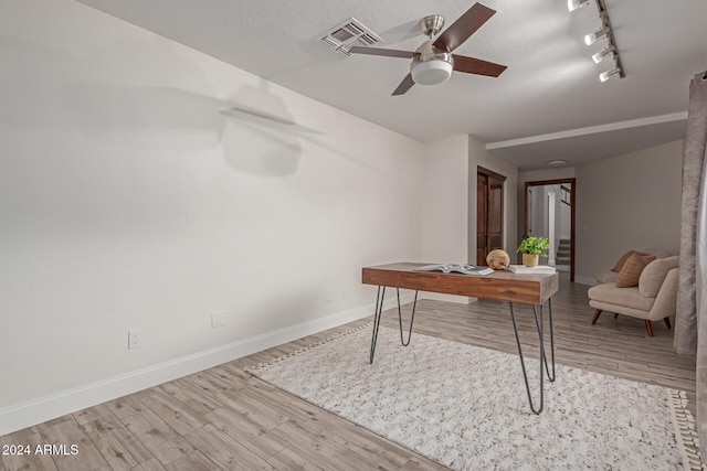 office space with ceiling fan, track lighting, and light wood-type flooring