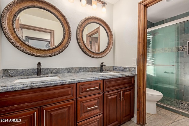 bathroom featuring tile patterned flooring, vanity, toilet, and walk in shower