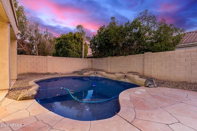 view of pool at dusk