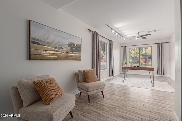 sitting room featuring track lighting, ceiling fan, and light hardwood / wood-style flooring