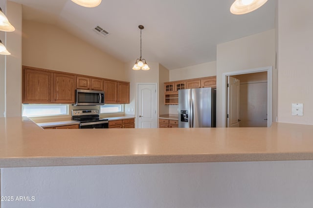 kitchen featuring pendant lighting, lofted ceiling, appliances with stainless steel finishes, and an inviting chandelier