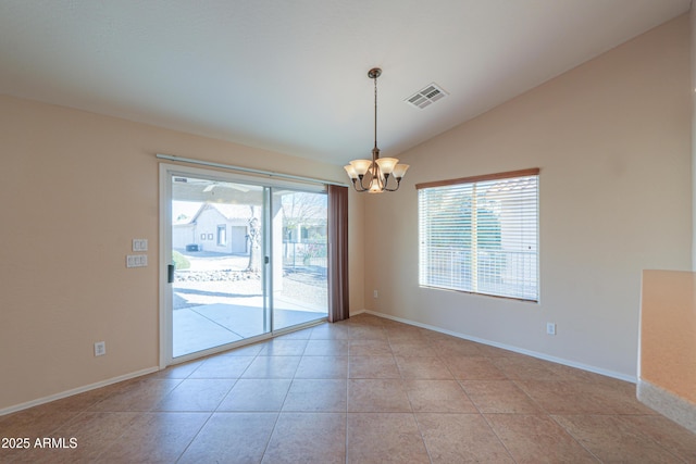 empty room with light tile patterned floors, vaulted ceiling, and a notable chandelier