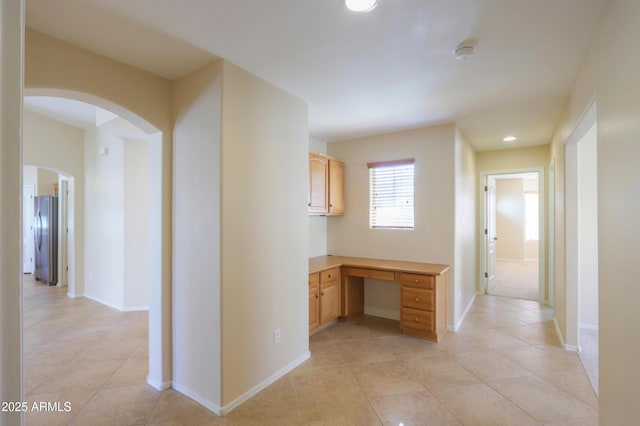 hall with light tile patterned floors