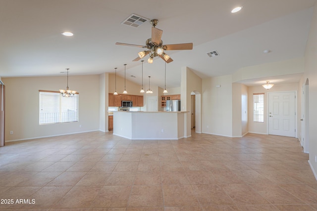 unfurnished living room with light tile patterned floors, vaulted ceiling, and a healthy amount of sunlight