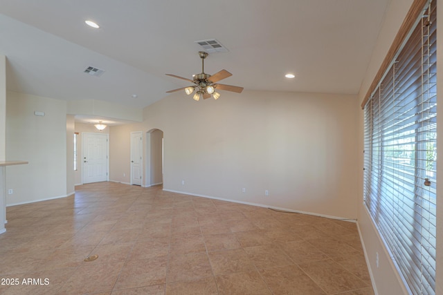 spare room featuring ceiling fan, light tile patterned floors, and vaulted ceiling