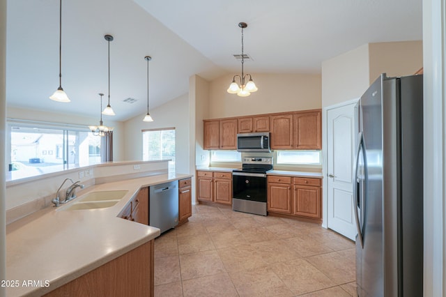 kitchen featuring lofted ceiling, sink, hanging light fixtures, stainless steel appliances, and a chandelier