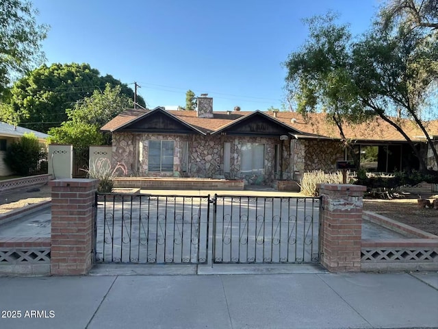 344 E Aepli Dr, Tempe, AZ 85282 - ranch-style home featuring stone siding, a fenced front yard, and a chimney