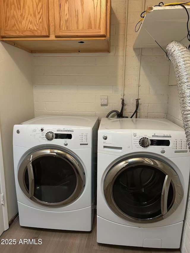 344 E Aepli Dr, Tempe, AZ 85282 - washroom featuring cabinet space, washing machine and dryer, and wood finished floors