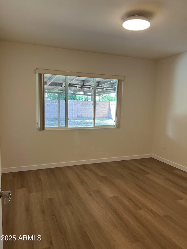 344 E Aepli Dr, Tempe, AZ 85282 - unfurnished room featuring plenty of natural light and wood finished floors