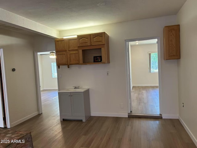 344 E Aepli Dr, Tempe, AZ 85282 - kitchen with wood finished floors, ceiling fan, brown cabinets, and light countertops