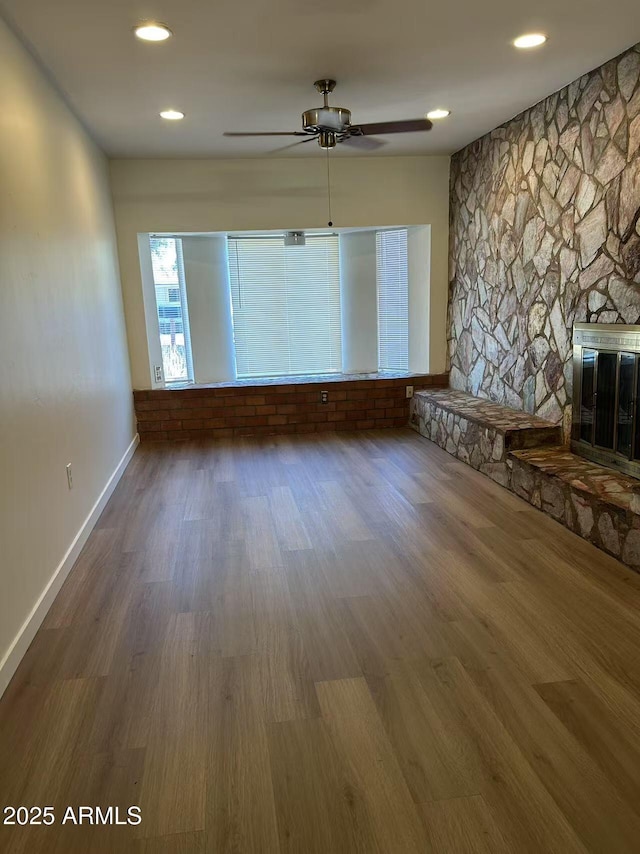 344 E Aepli Dr, Tempe, AZ 85282 - unfurnished living room with ceiling fan, wood finished floors, a glass covered fireplace, and recessed lighting