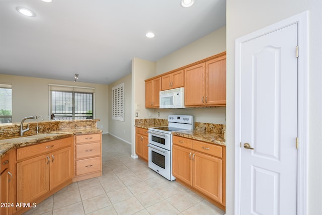 kitchen featuring light stone counters, white appliances, sink, and light tile patterned floors