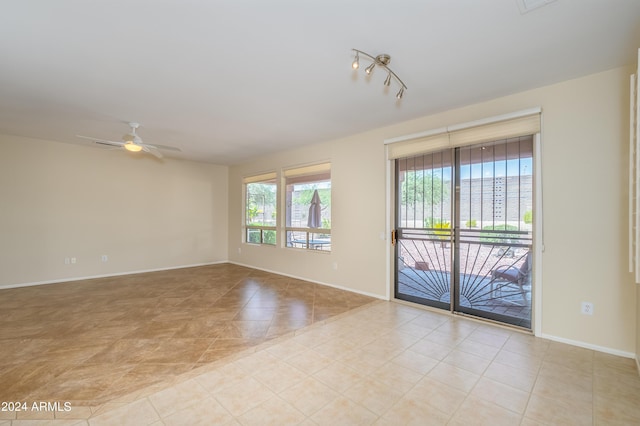 tiled empty room with ceiling fan