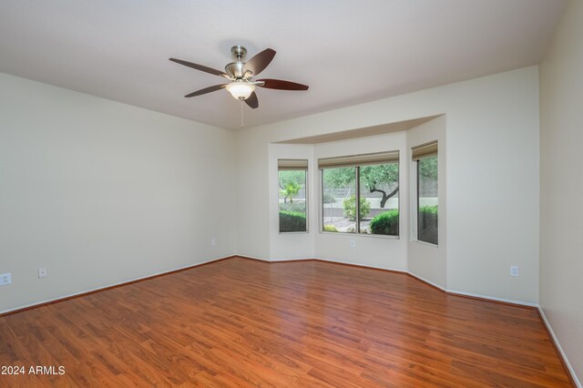 empty room featuring wood-type flooring and ceiling fan