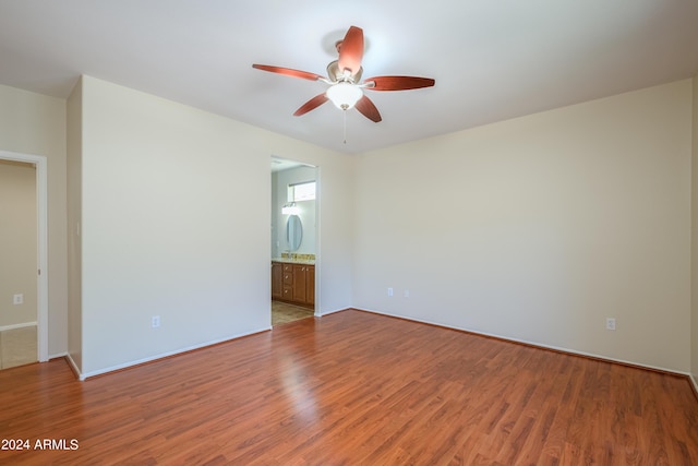 spare room with ceiling fan and wood-type flooring