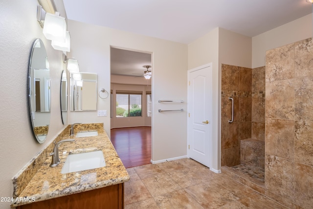 bathroom featuring vanity, a tile shower, and ceiling fan