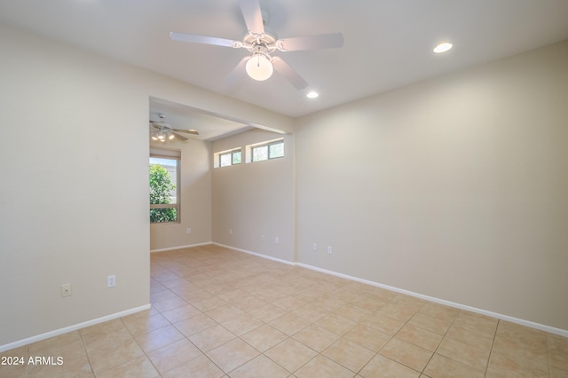 tiled empty room with ceiling fan