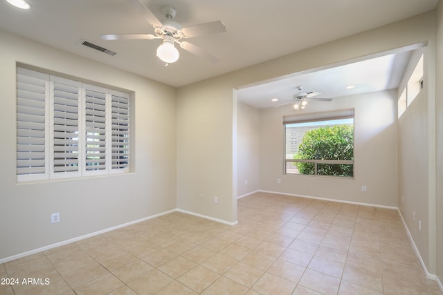 spare room with light tile patterned flooring and ceiling fan