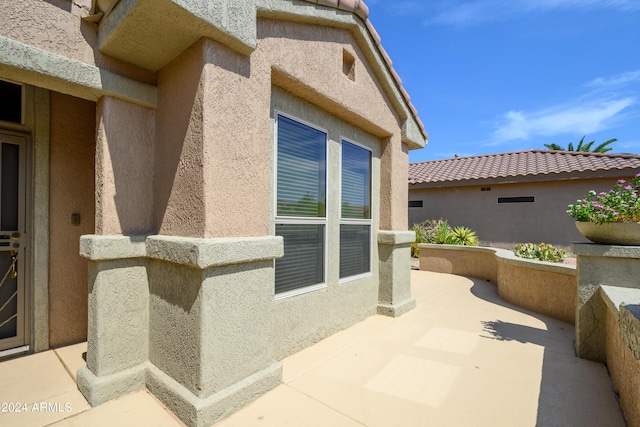 view of side of property featuring a patio