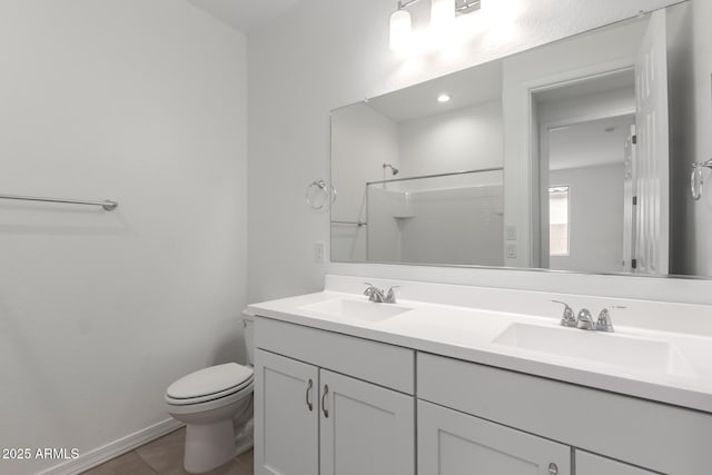 bathroom with tile patterned floors, vanity, toilet, and a shower