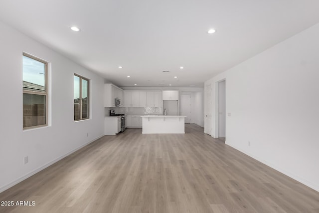 unfurnished living room featuring light hardwood / wood-style floors