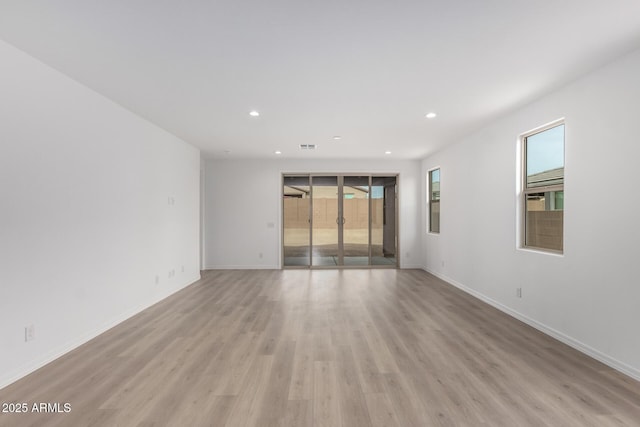 empty room with light hardwood / wood-style floors