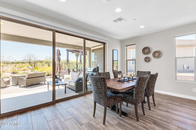 dining room featuring hardwood / wood-style floors and a healthy amount of sunlight