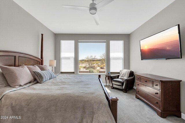 bedroom featuring light colored carpet and ceiling fan