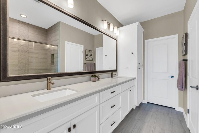 bathroom featuring vanity and an enclosed shower