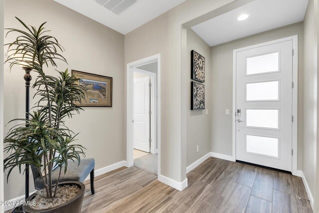 entrance foyer featuring plenty of natural light and light hardwood / wood-style flooring