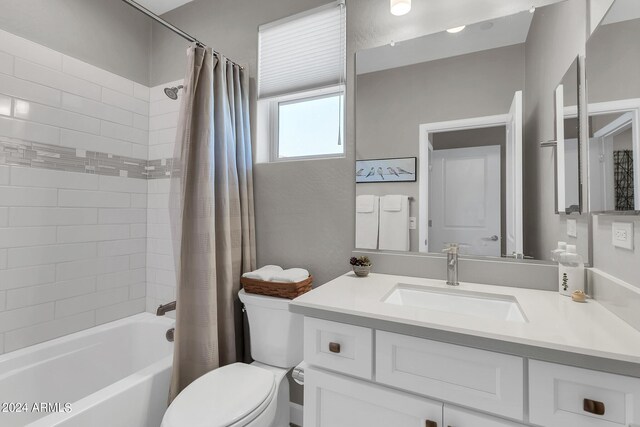 full bathroom featuring vanity, toilet, and shower / bath combination with curtain