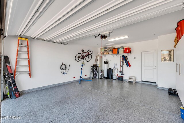 garage with a garage door opener and water heater