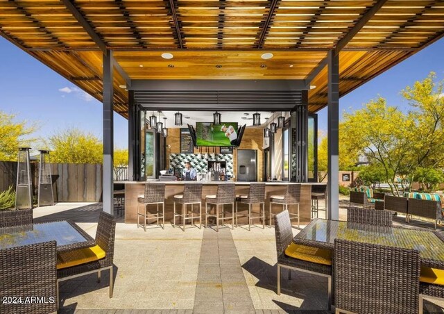 view of patio featuring an outdoor bar