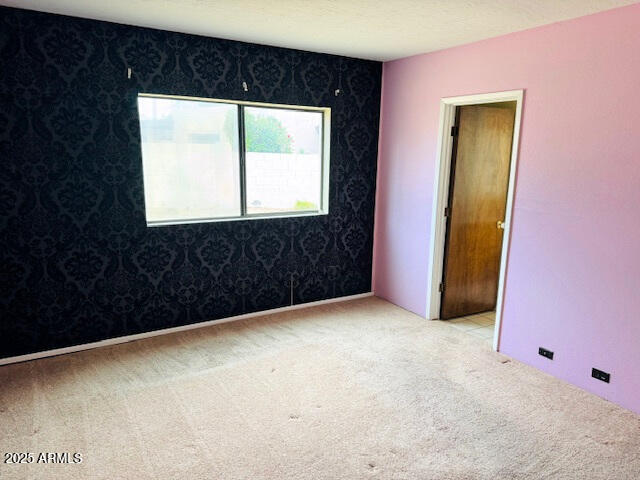 4727 E Euclid Ave, Phoenix, AZ 85044 - carpeted empty room with wallpapered walls