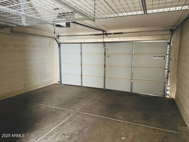 4727 E Euclid Ave, Phoenix, AZ 85044 - garage featuring concrete block wall and a garage door opener